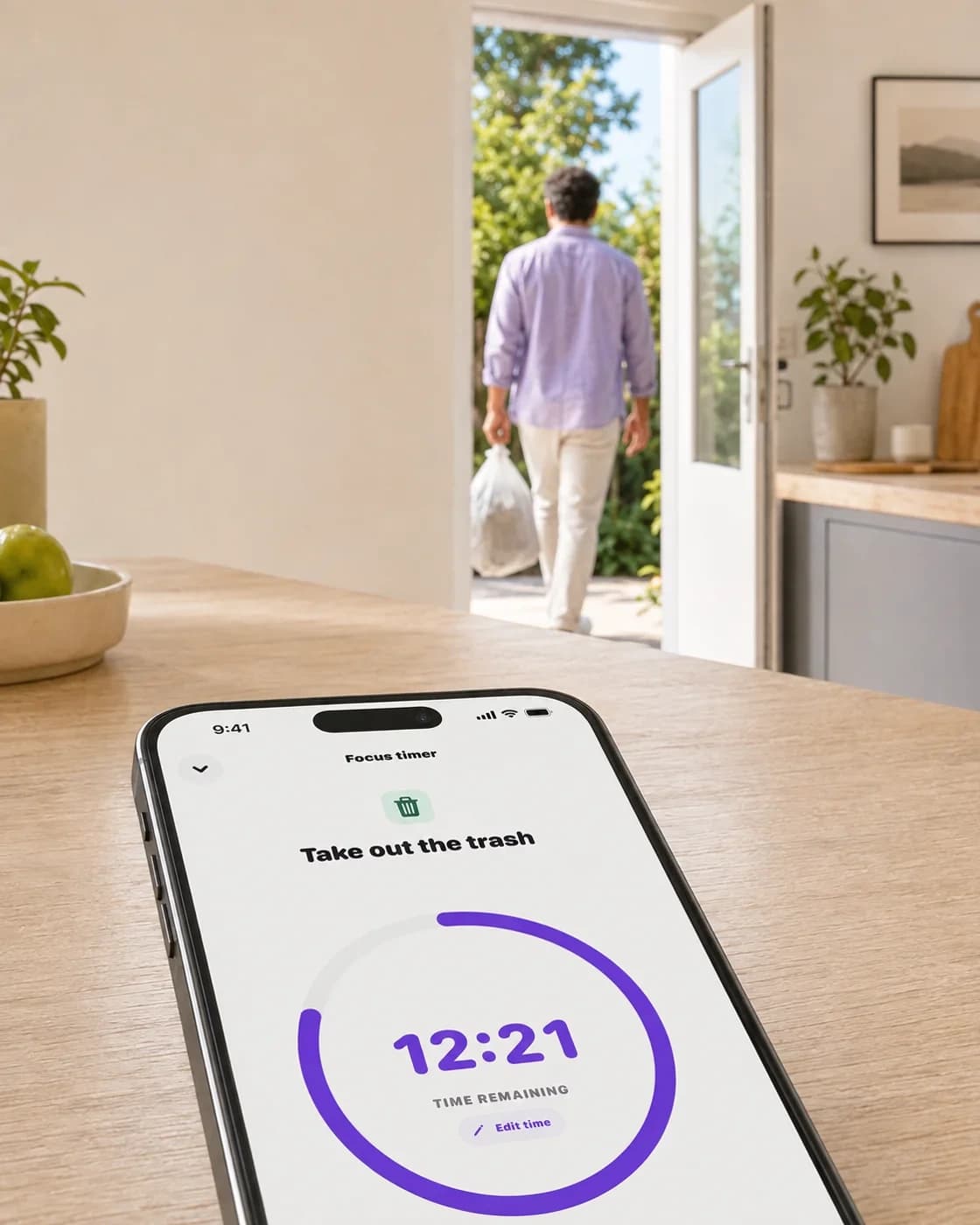 Nudge campaign scene showing a focus timer on a phone in a calm kitchen